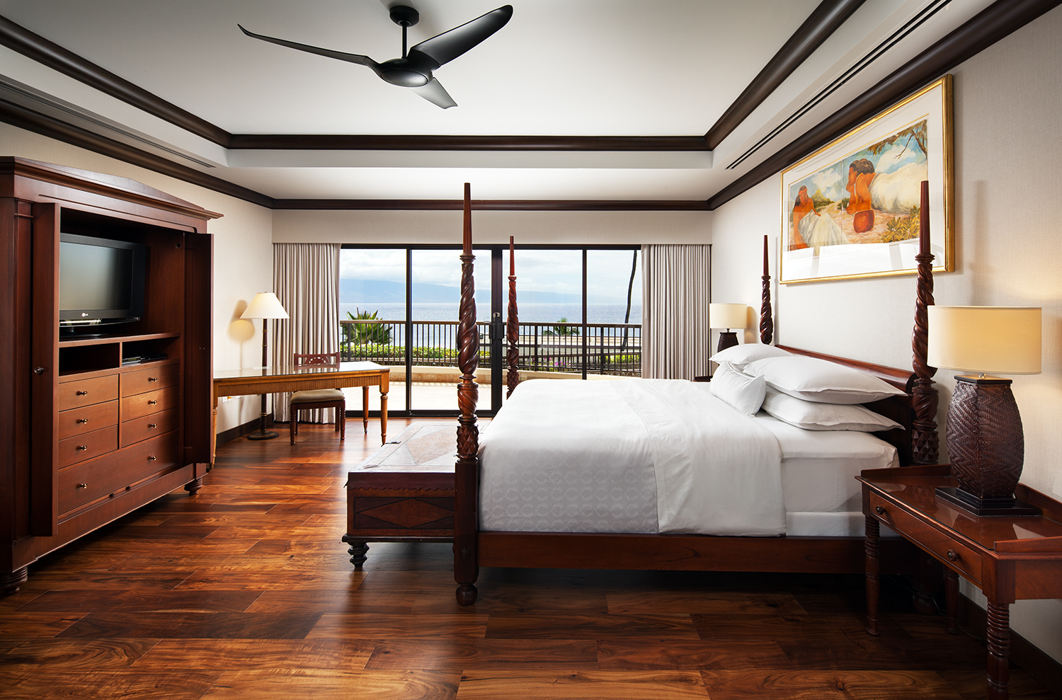 a bedroom with a large bed and a desk