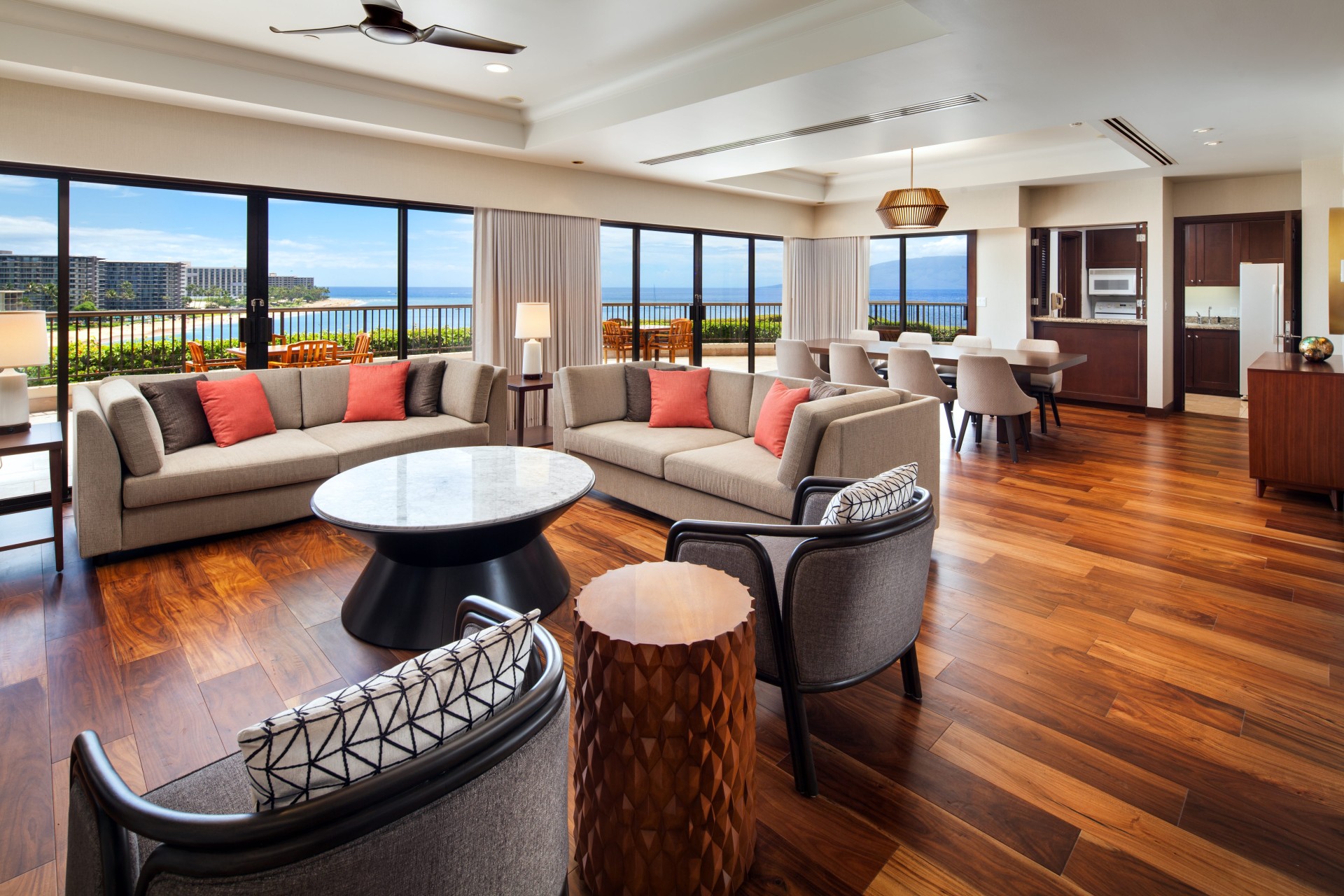 a living room with a large balcony overlooking the ocean