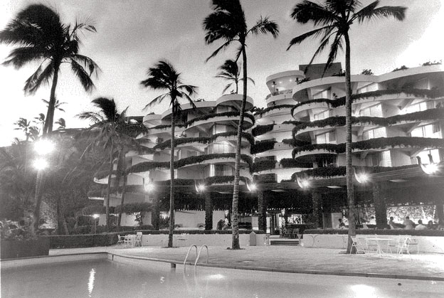 a building with palm trees and a pool