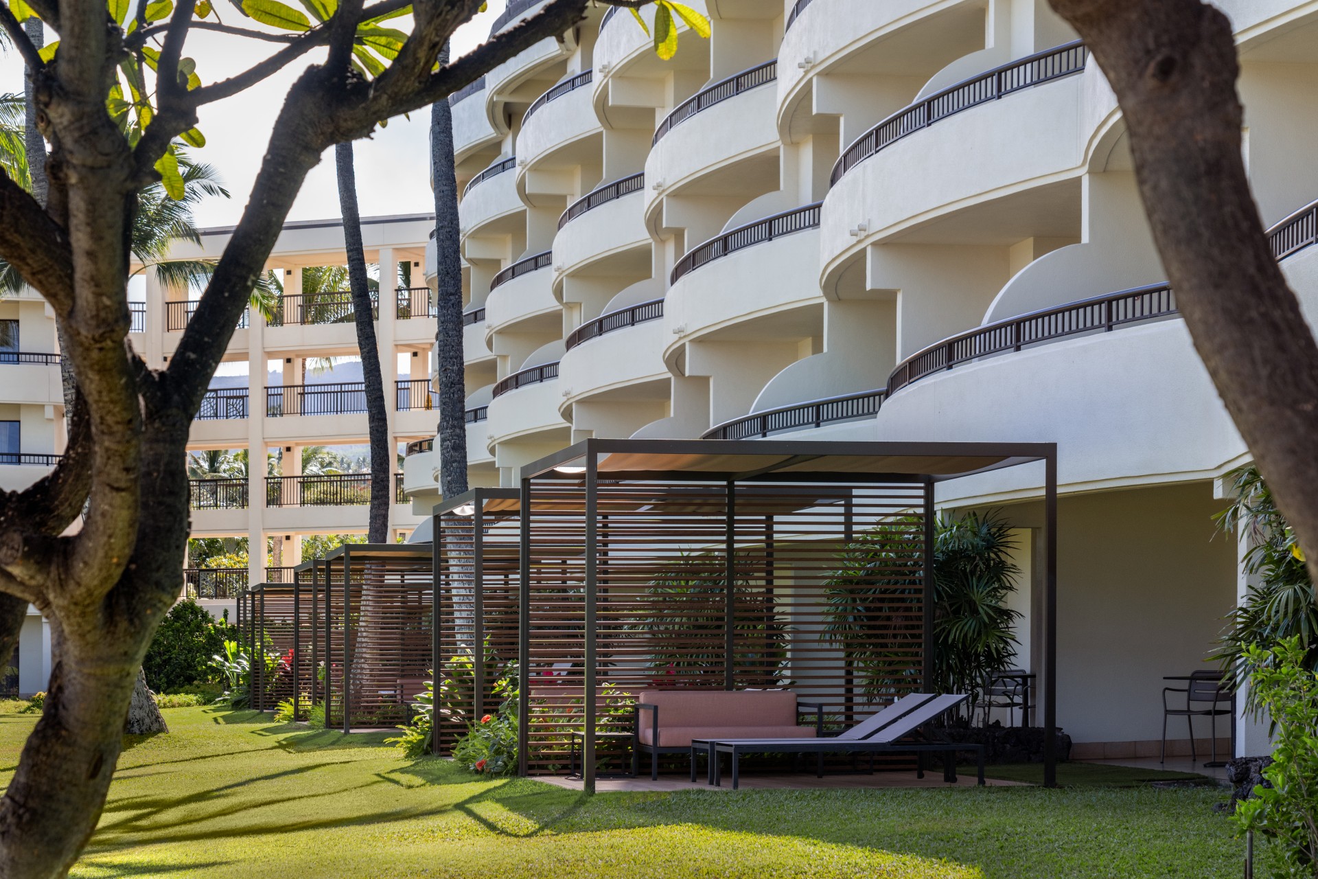 a group of lounge chairs in front of a white building