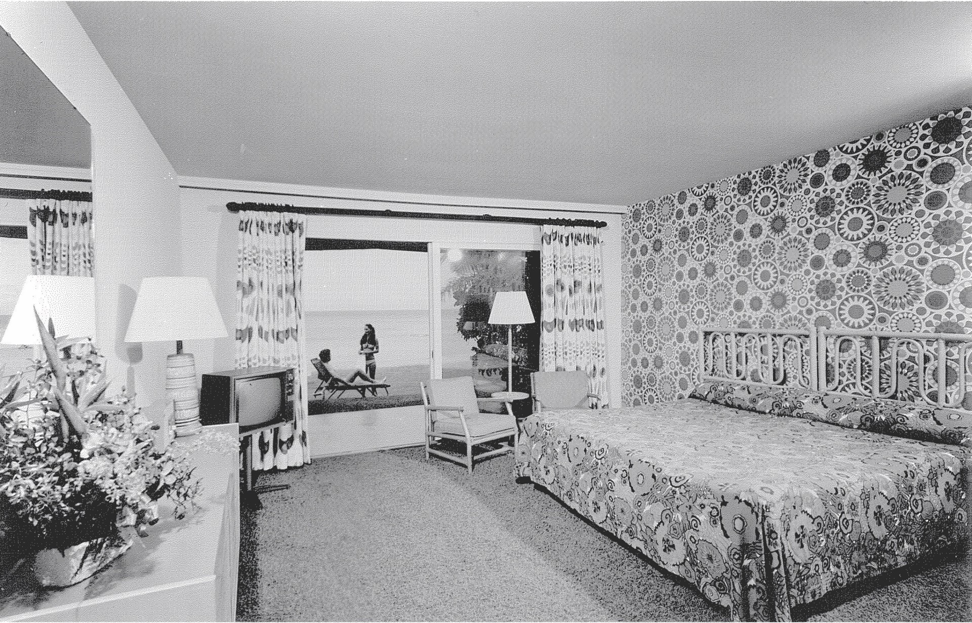 a bedroom with a bed and a television