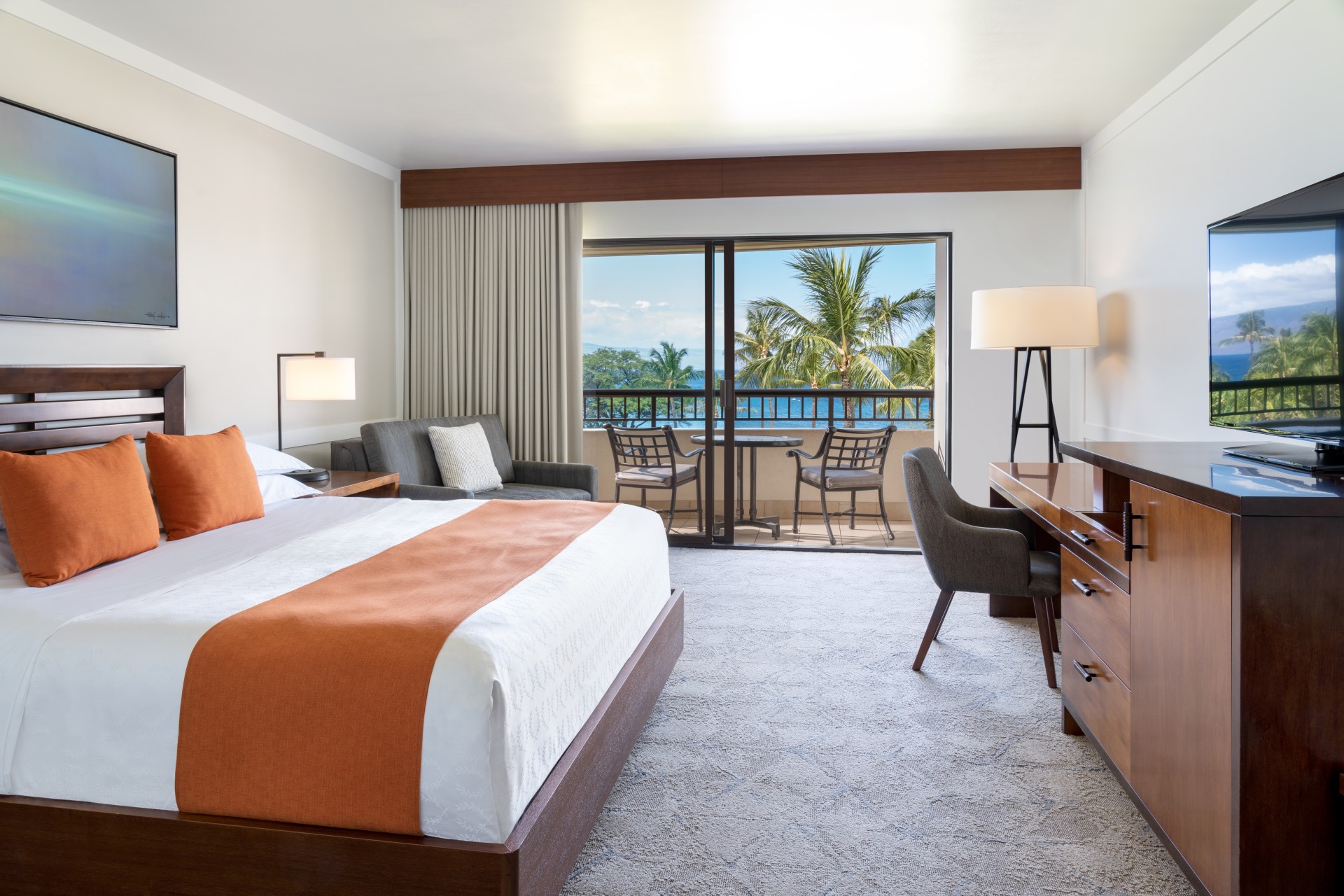 a room with a bed and a desk and chairs