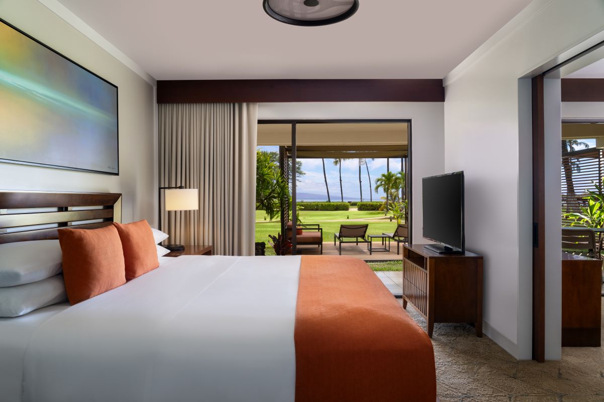 a room with a large bed and a television