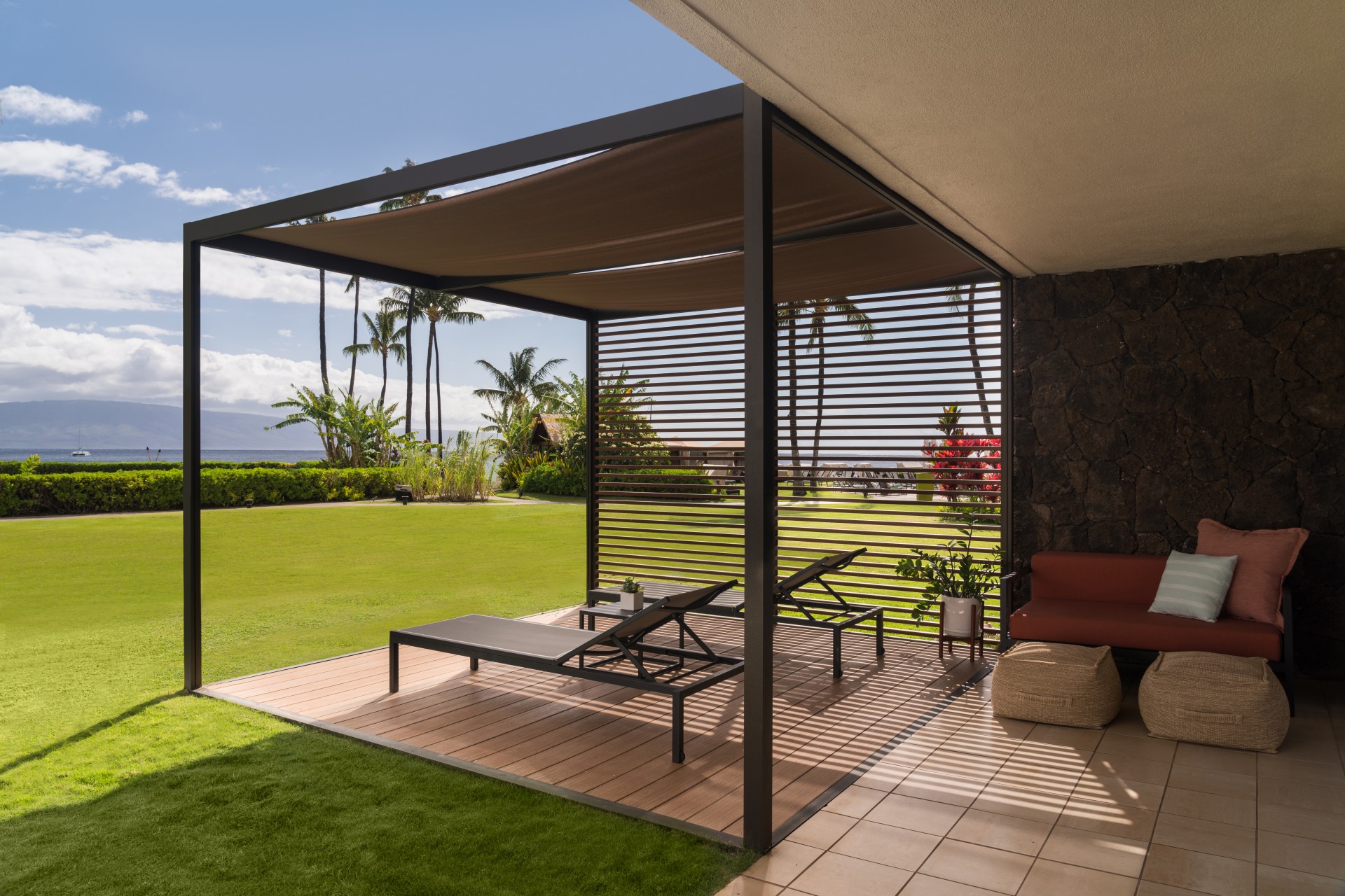 a patio with a covered deck and chairs