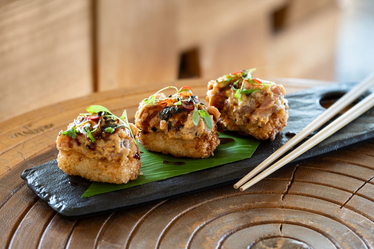 food on a plate with chopsticks