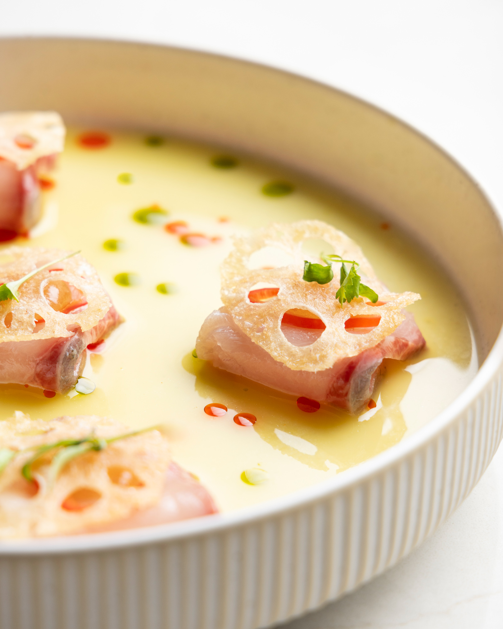 a bowl of soup with meat and herbs