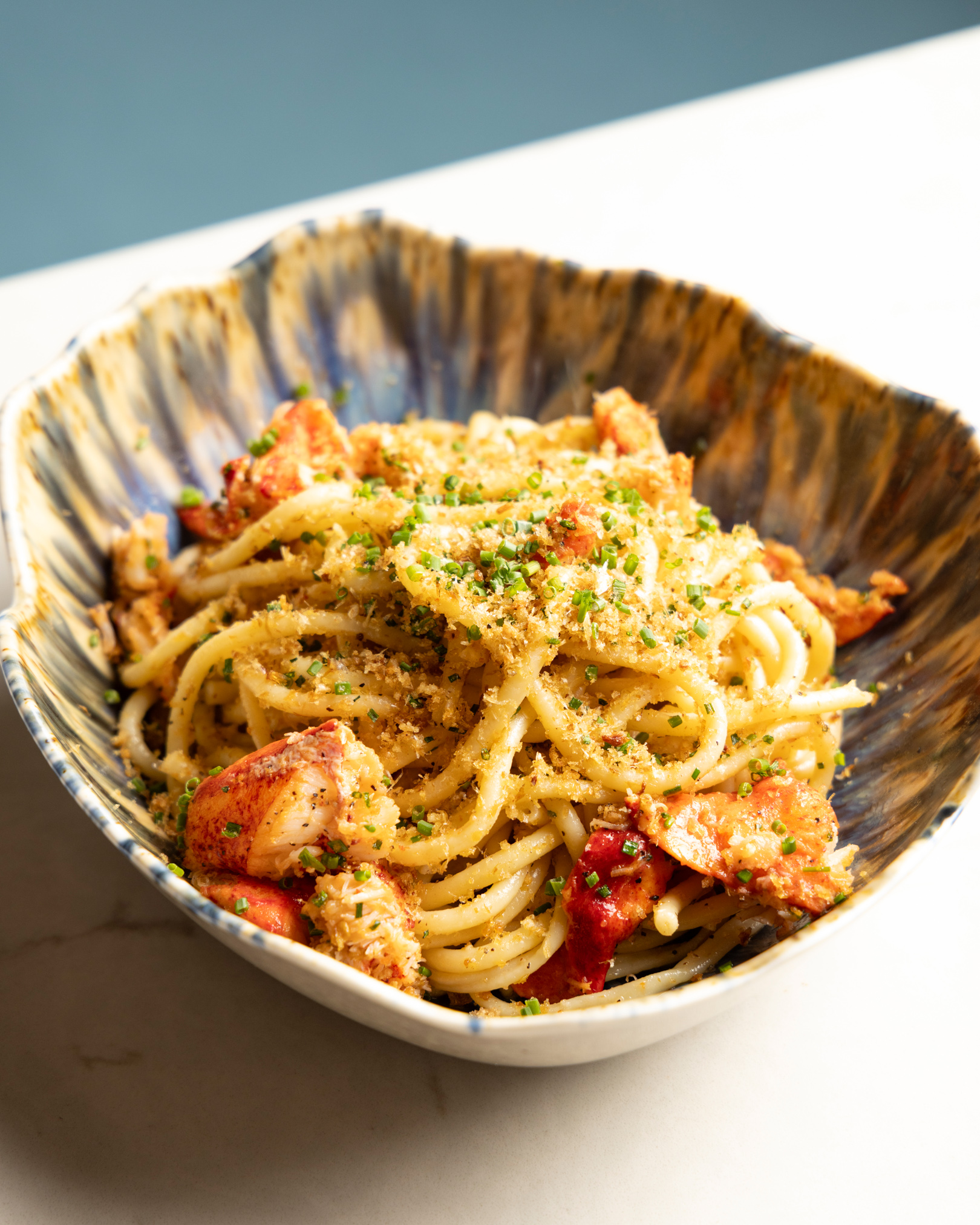 a bowl of pasta with meat and cheese