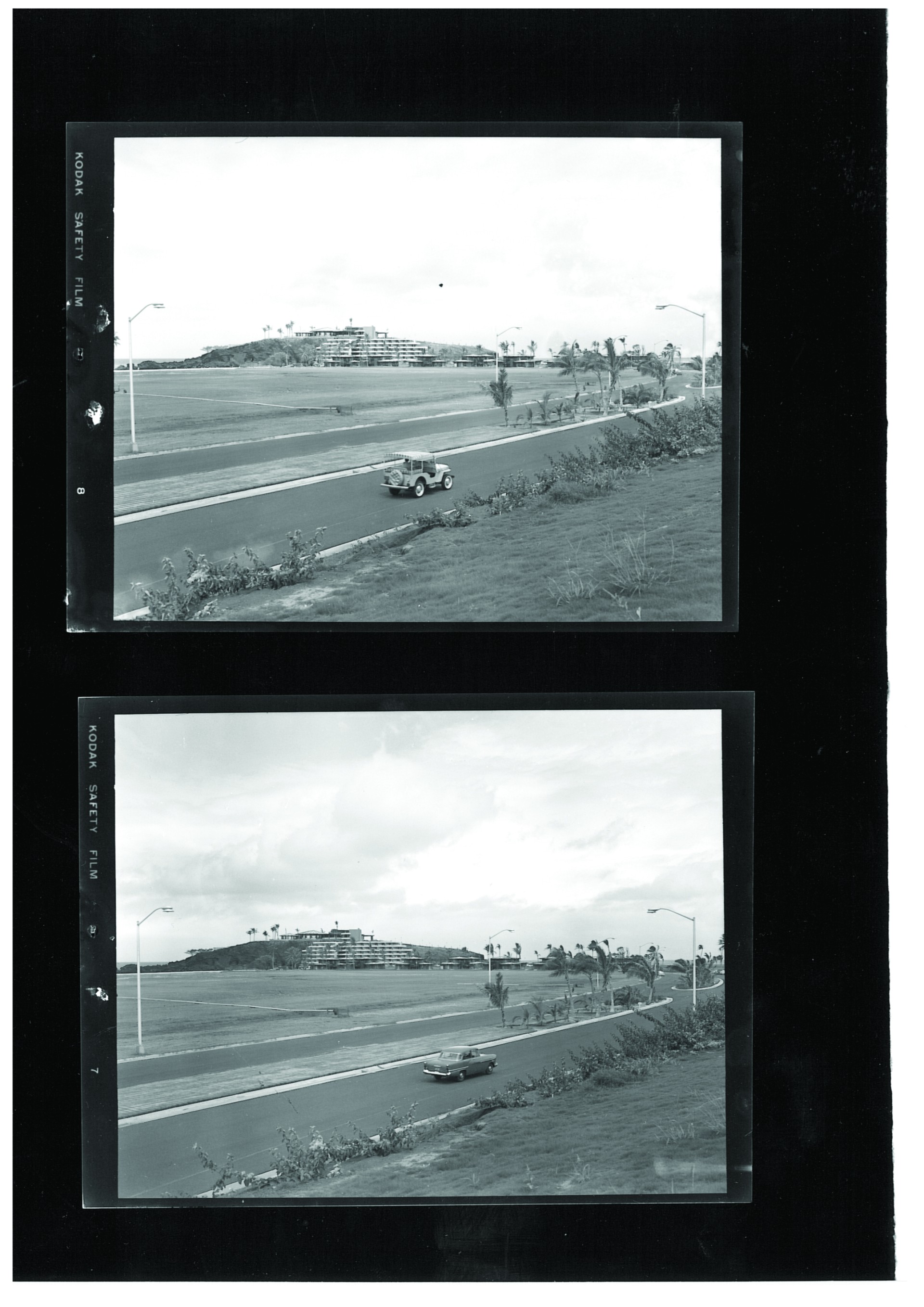 a black and white photo of a road with cars