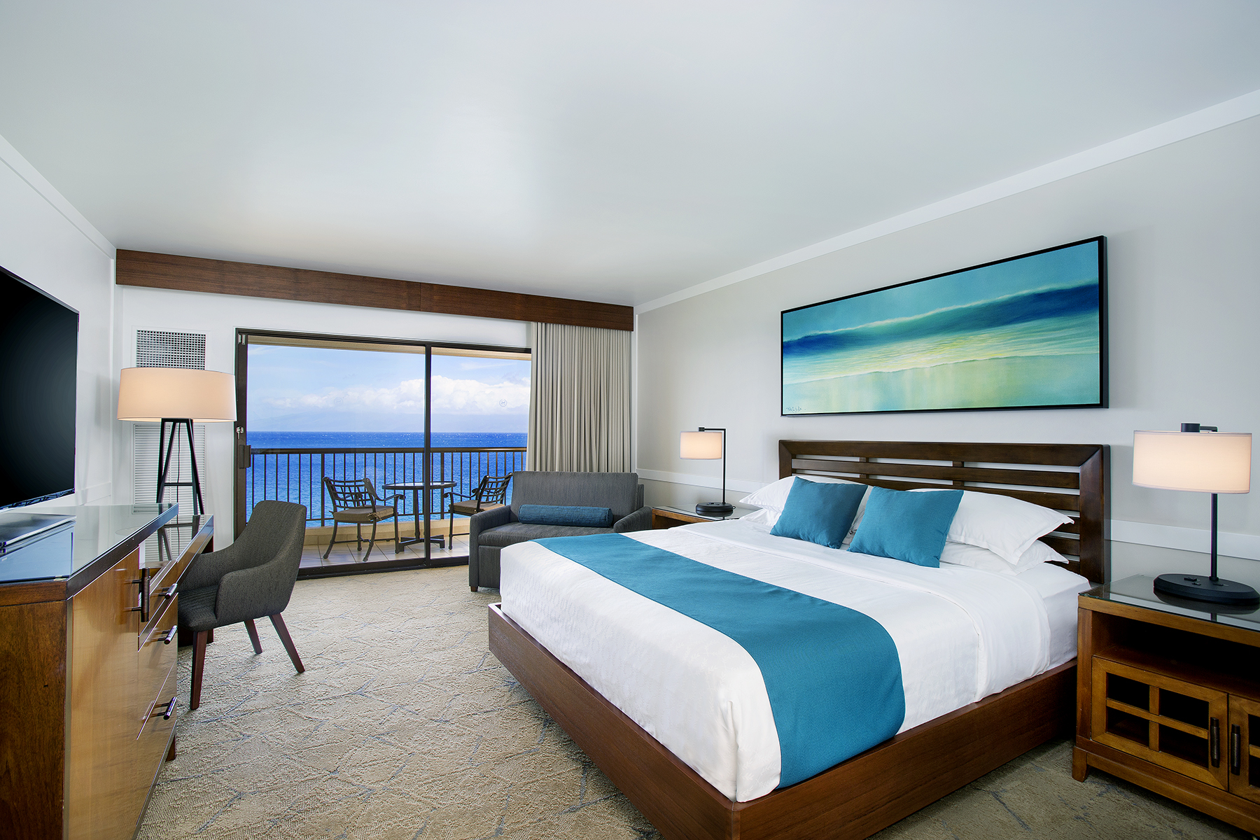 a room with a bed and a chair and a table