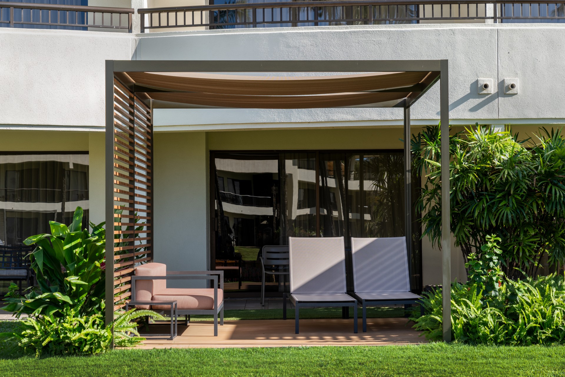 a patio with chairs and a pergola