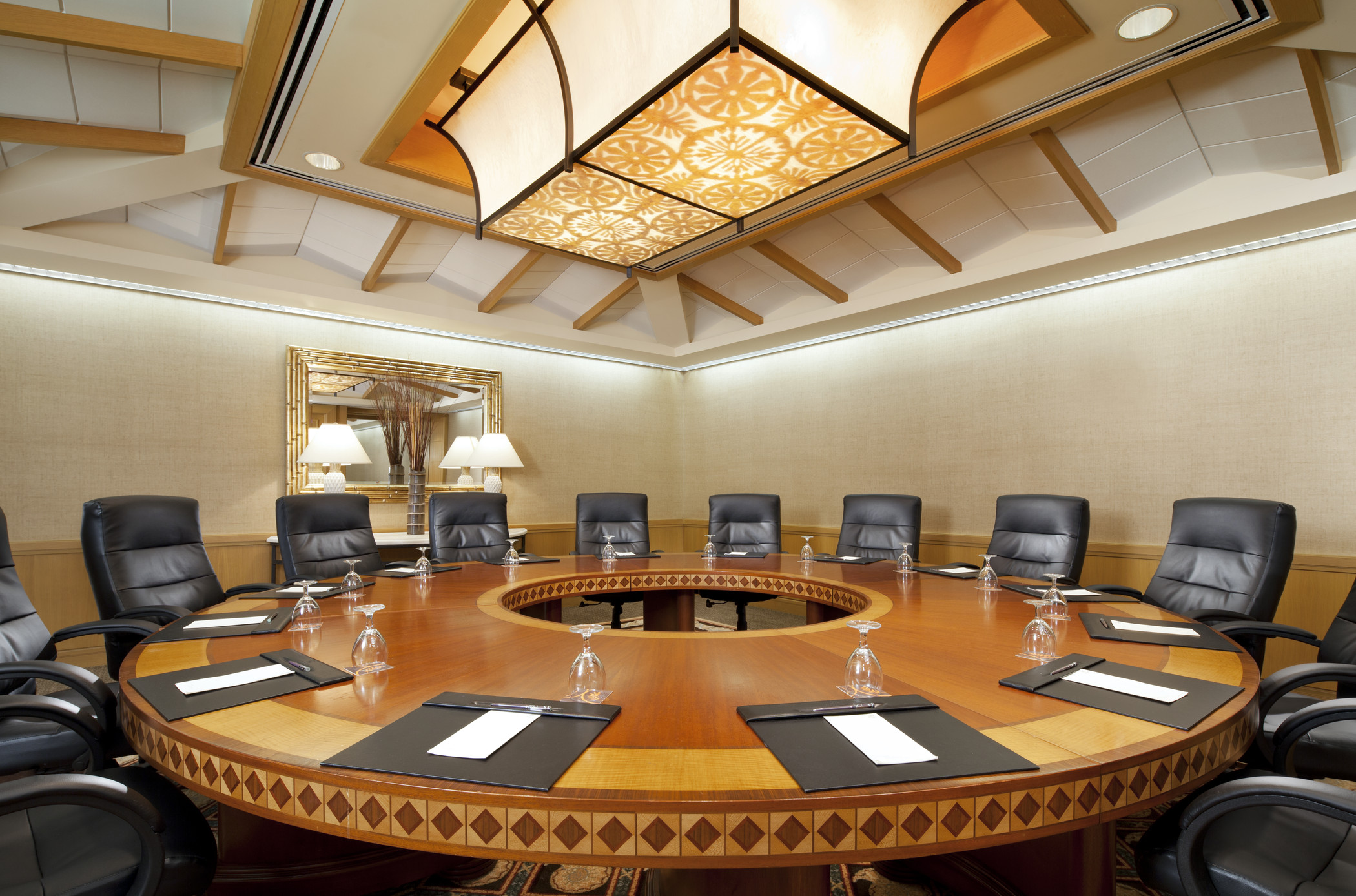 a conference room with a round table and chairs