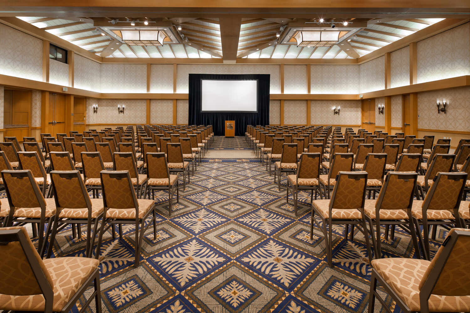 a room with many chairs and a screen