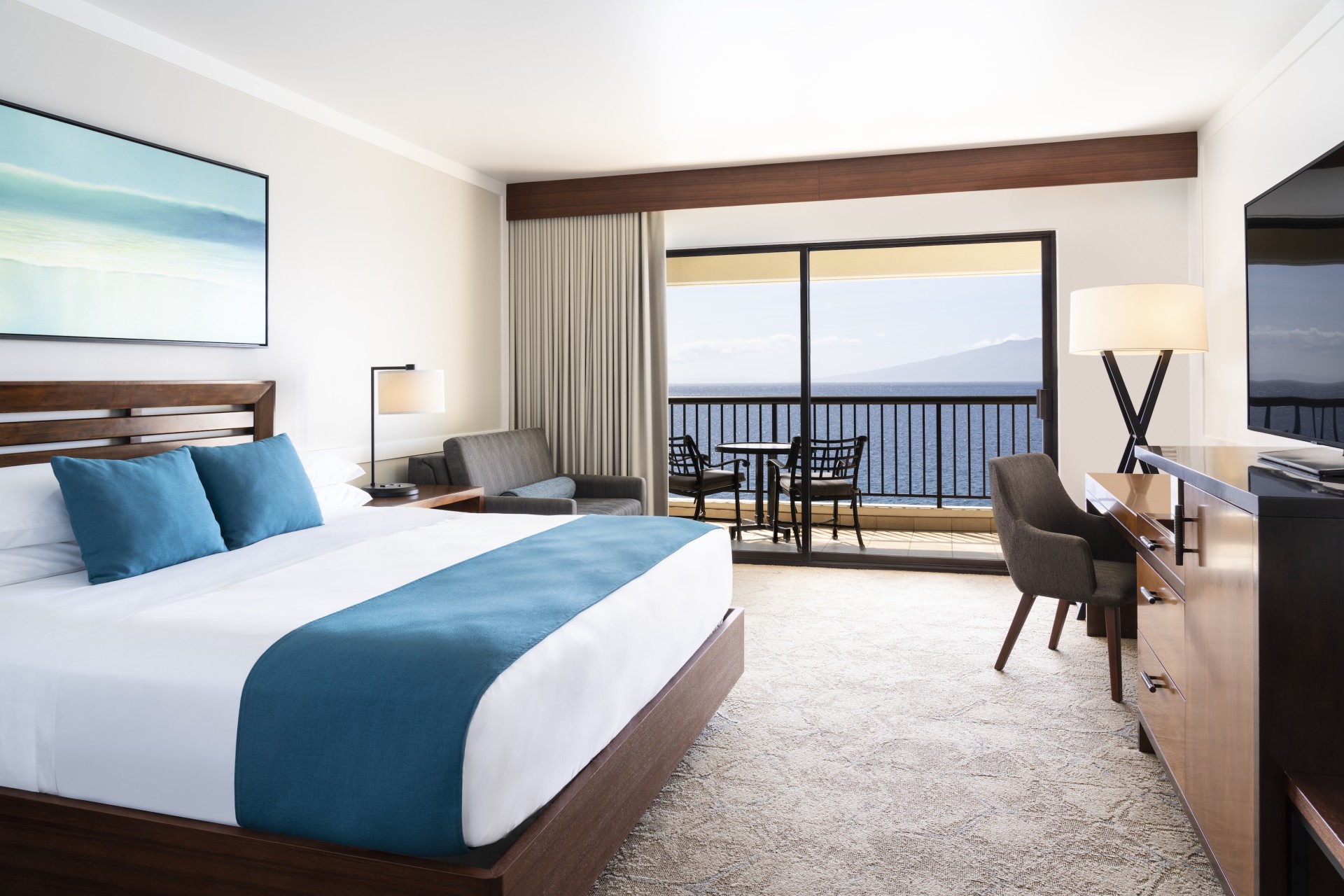 a room with a bed and a table and chairs