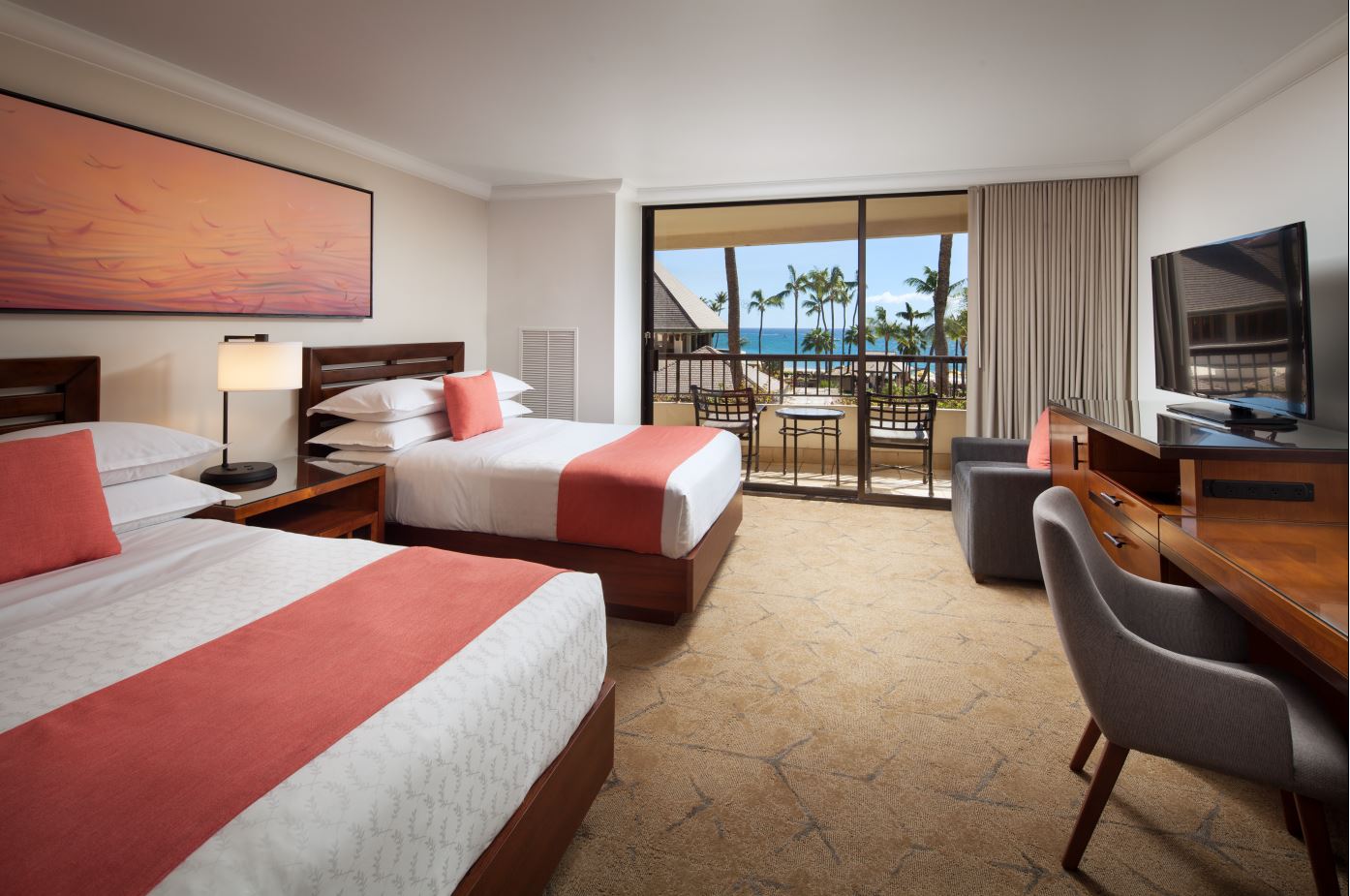 a room with two beds and a glass door