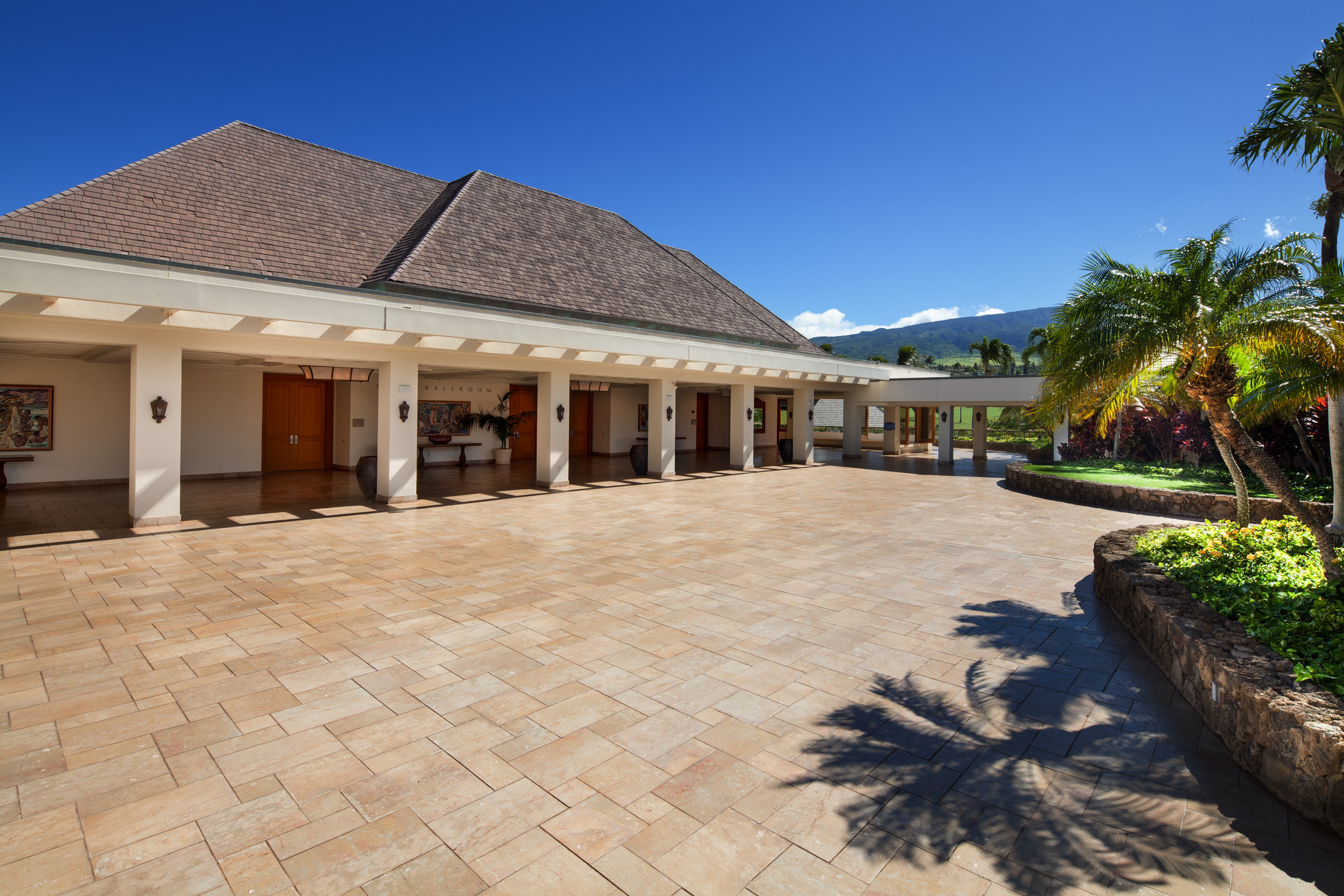 a building with columns and a stone patio