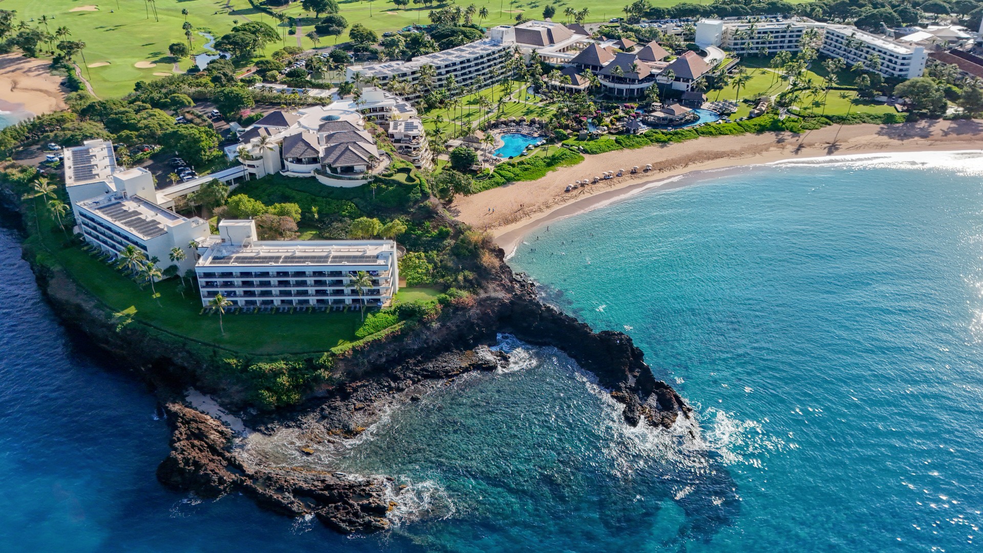 a beach with buildings and a pool