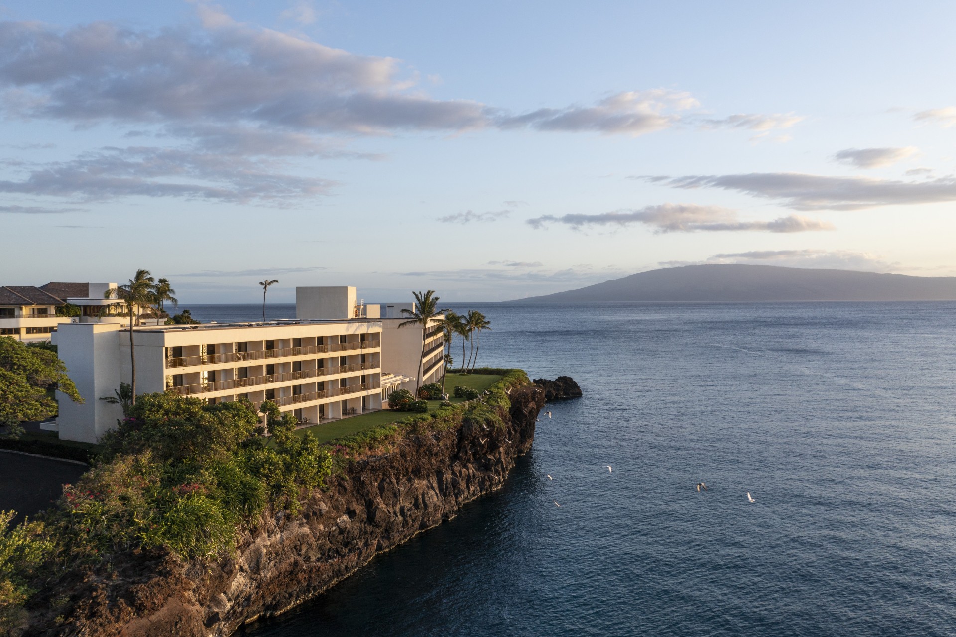 a building on a cliff by the water