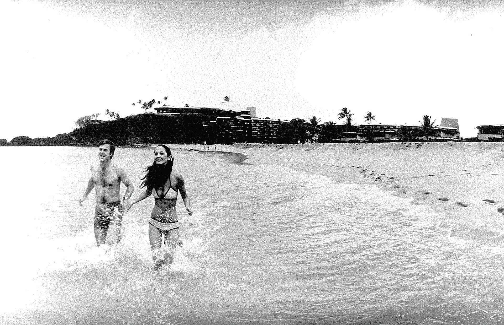 a man and woman running in water