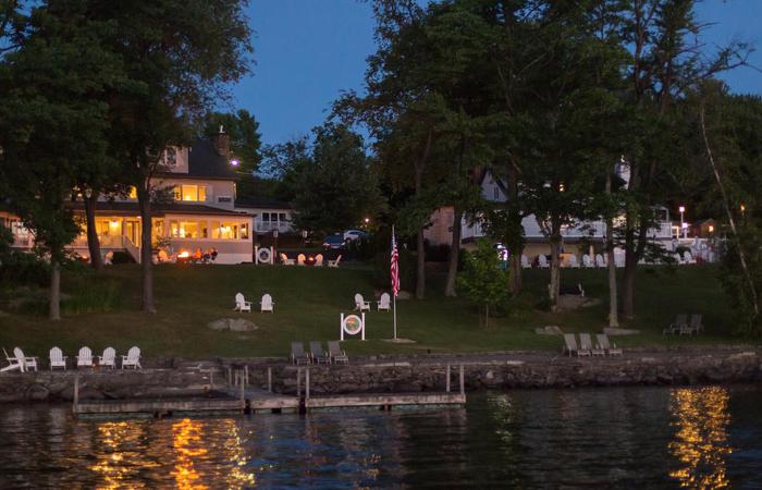 a house with a dock and trees by the water