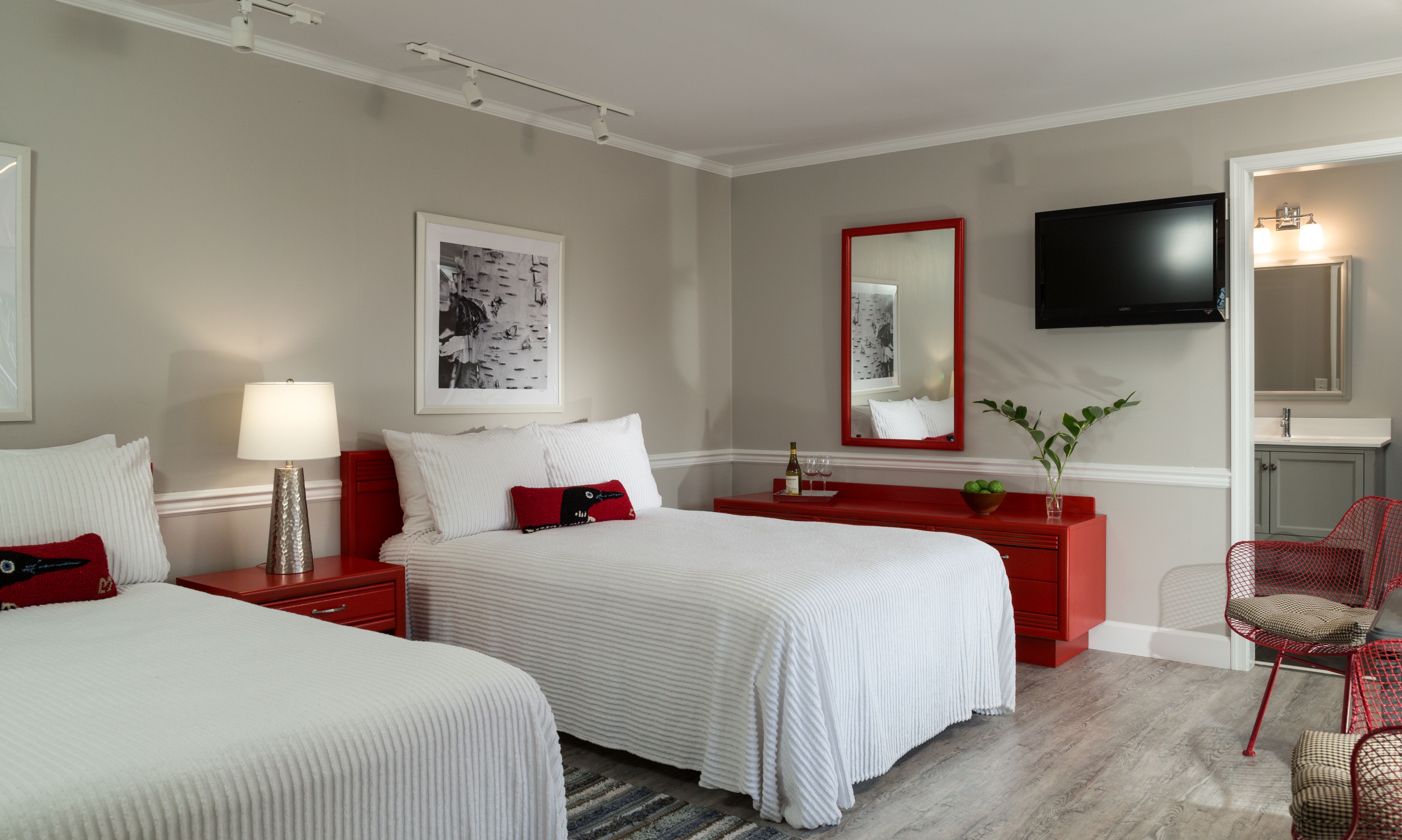 a room with two beds and a tv