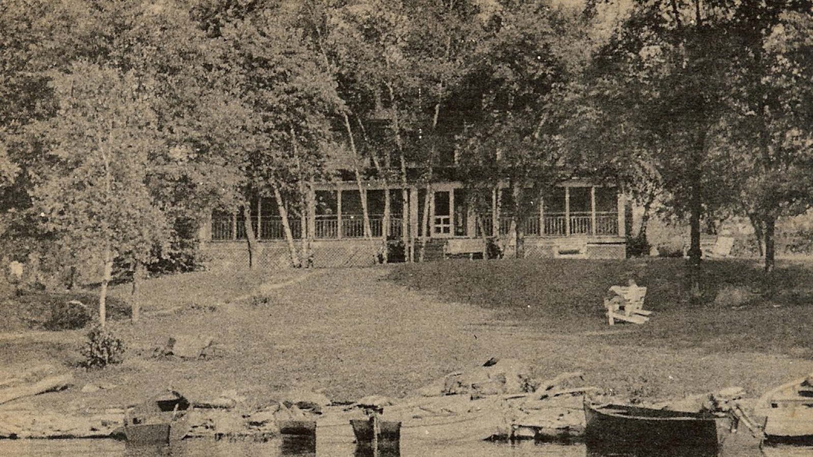a house with trees and a lake