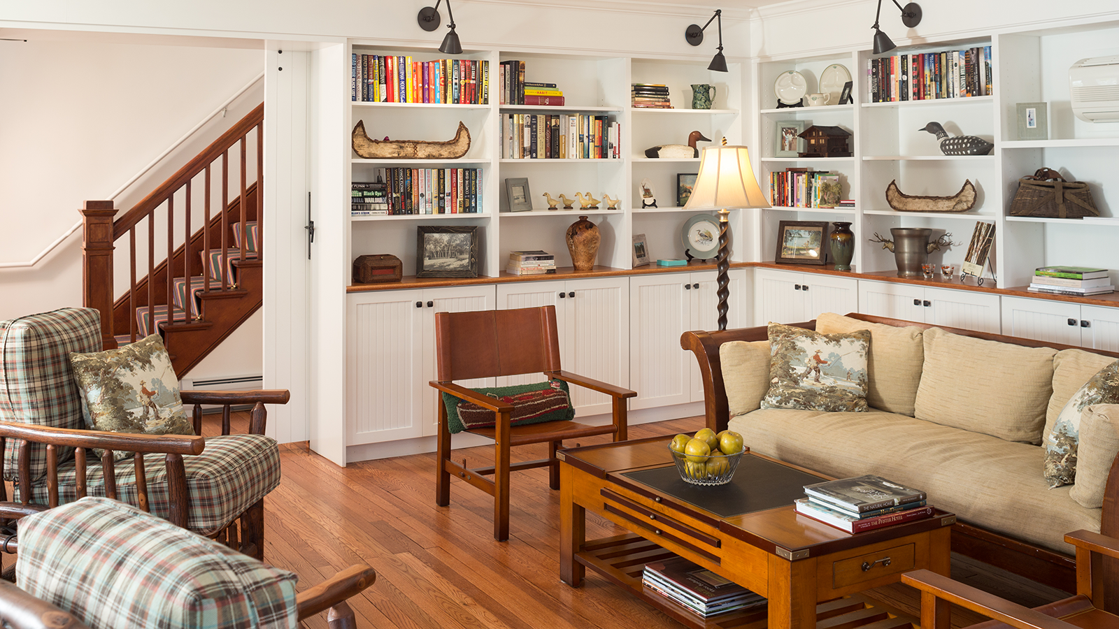 a living room with white shelves and a couch