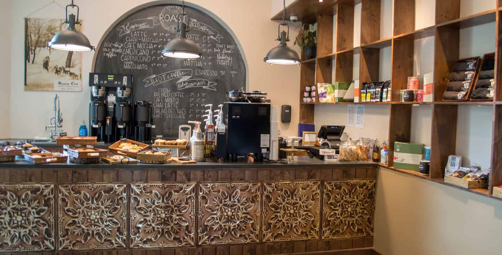 a coffee shop counter with a chalkboard