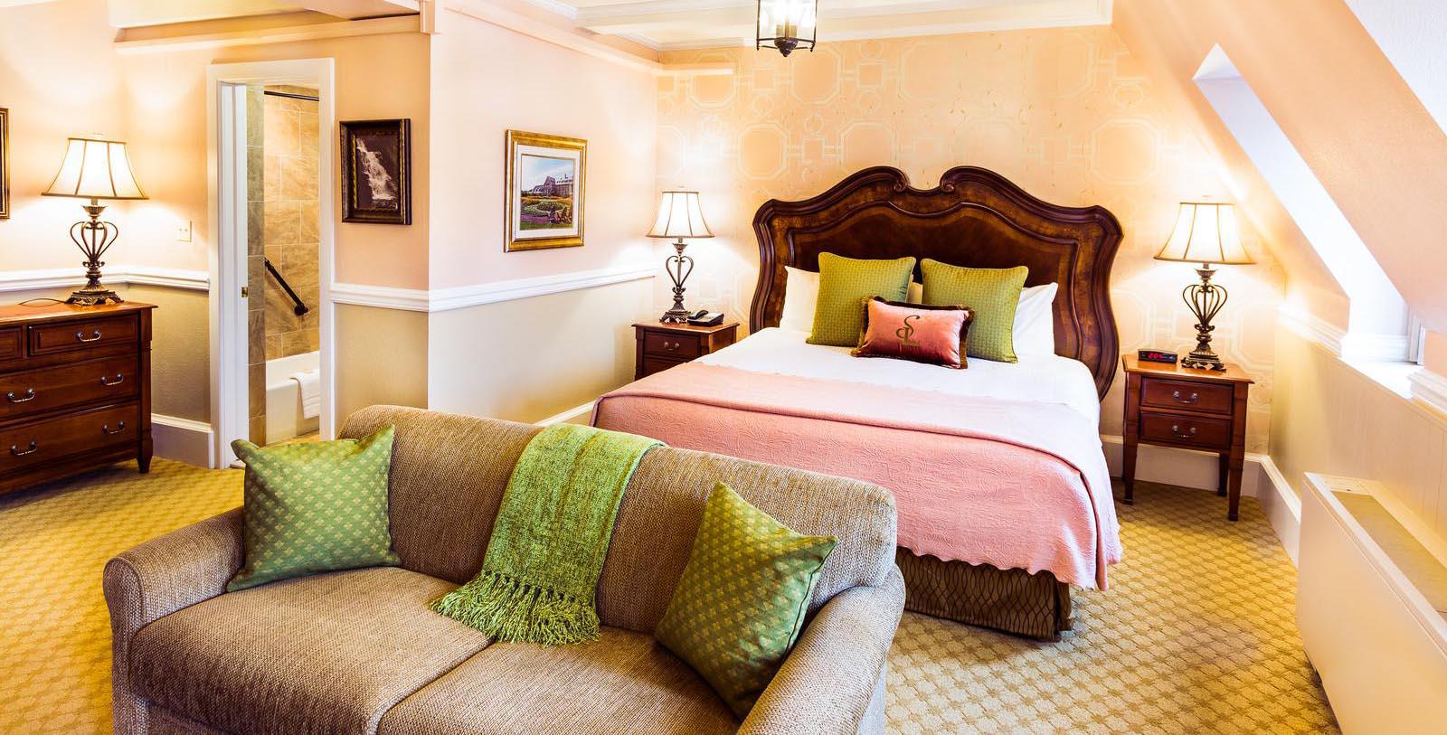 a bed and couch in a hotel room