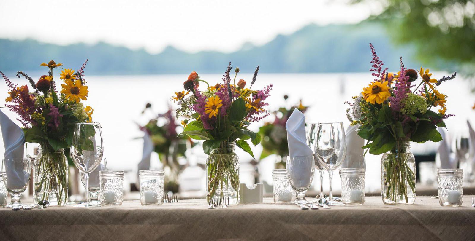 a table with flowers and glasses
