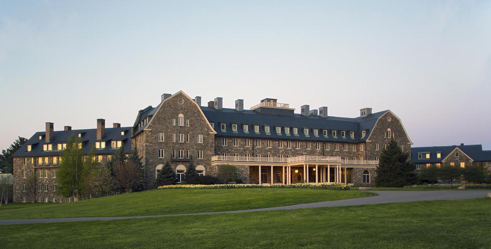 a large stone building with a lawn and grass