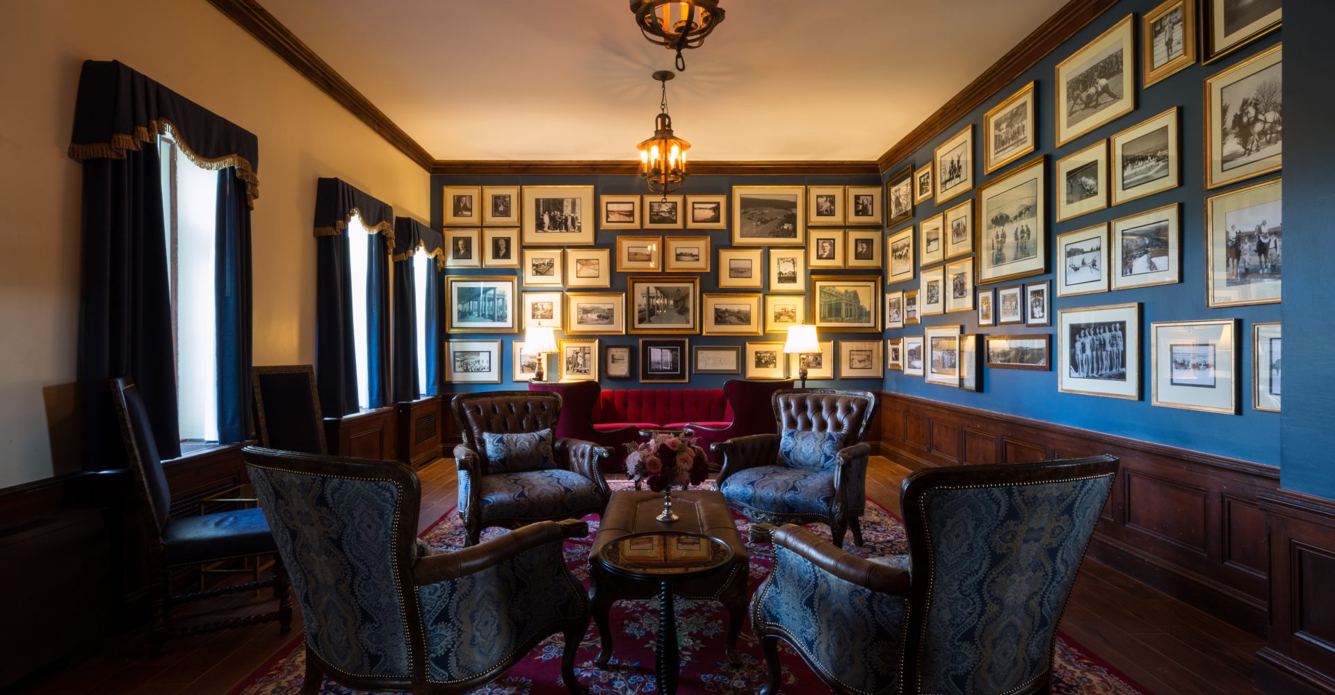 a room with a couch and chairs