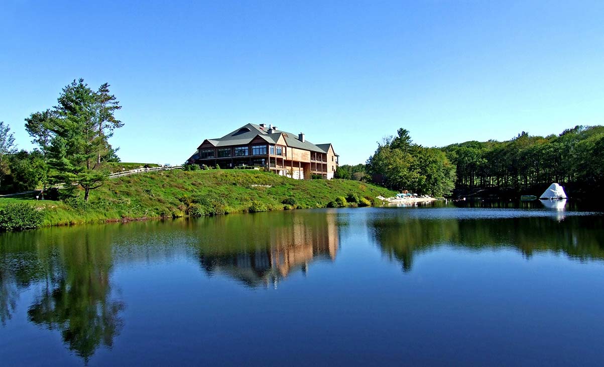 a house on the hill by a lake