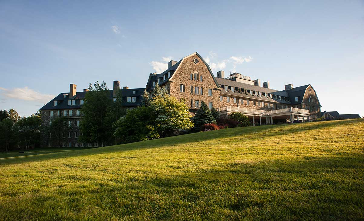 a large building with a lawn in front of it