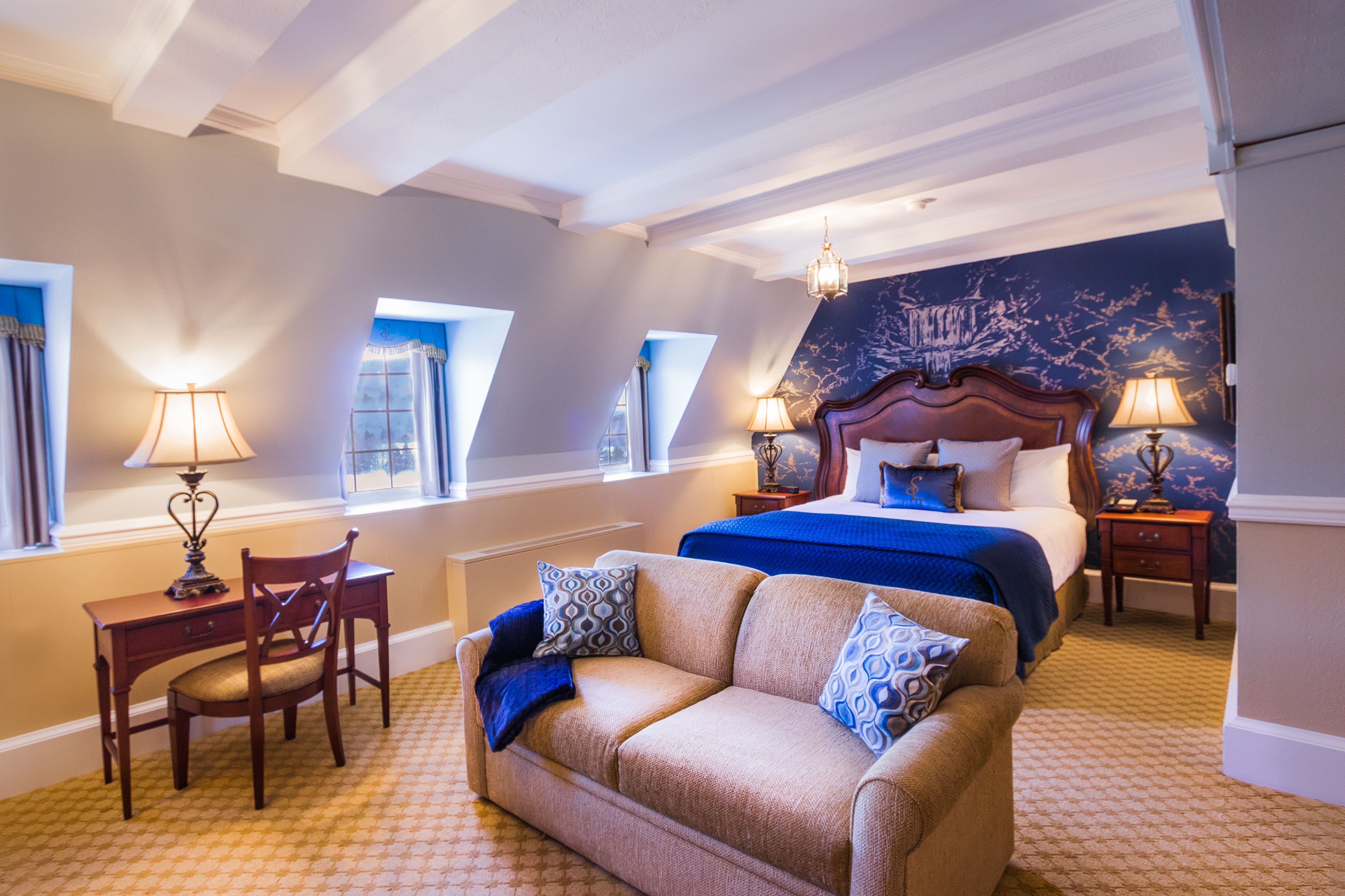 a bedroom with a bed and a couch