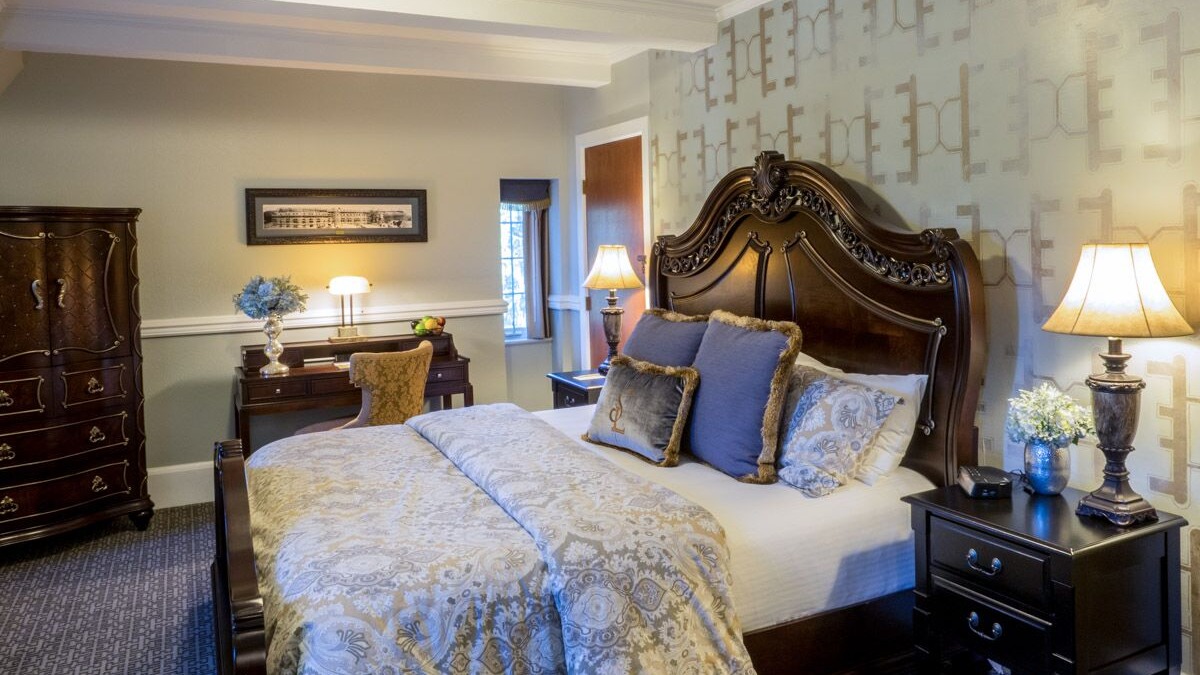 a bed with a lamp and a desk