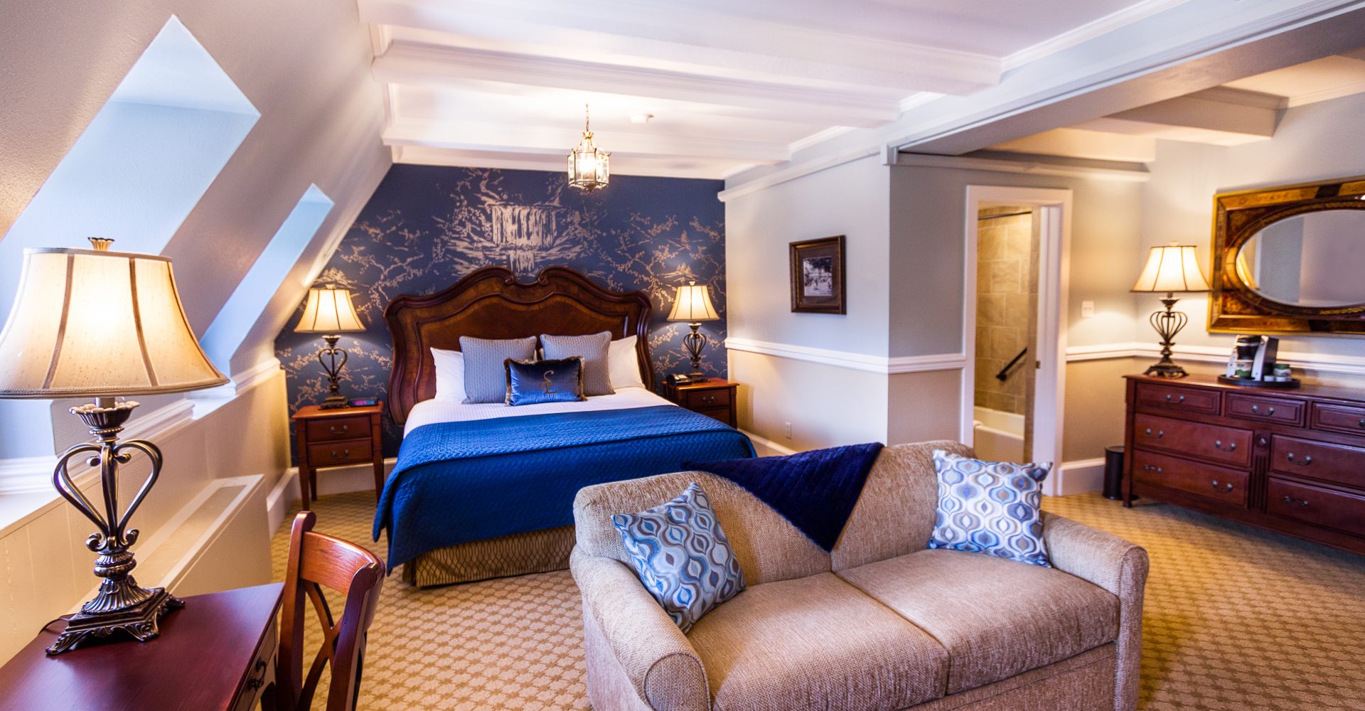 a bedroom with a bed and a couch