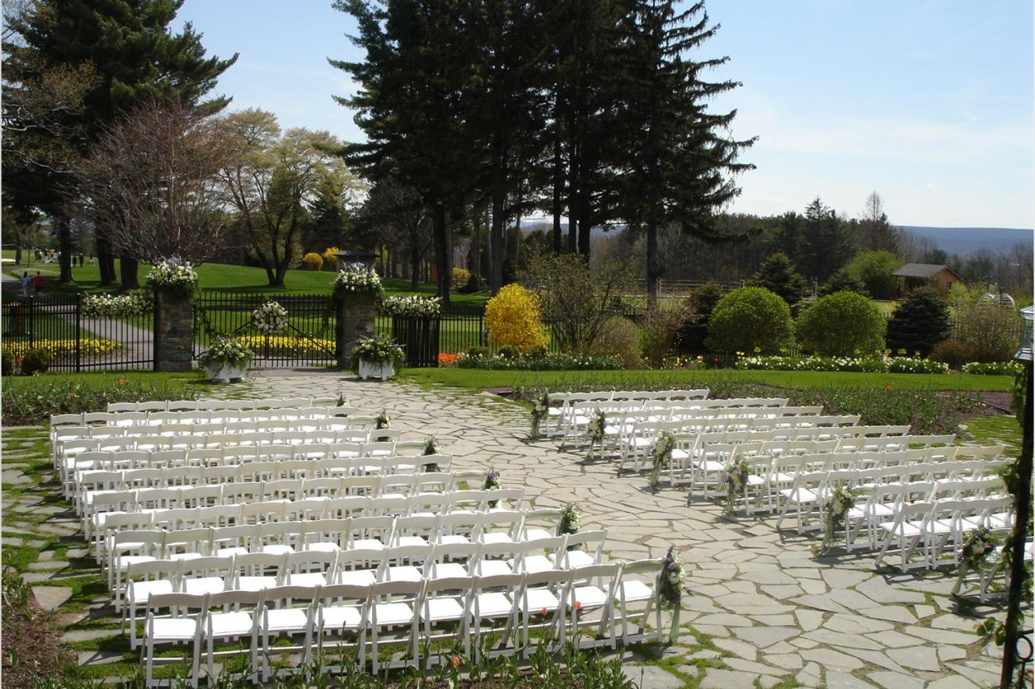 a group of white chairs in a garden