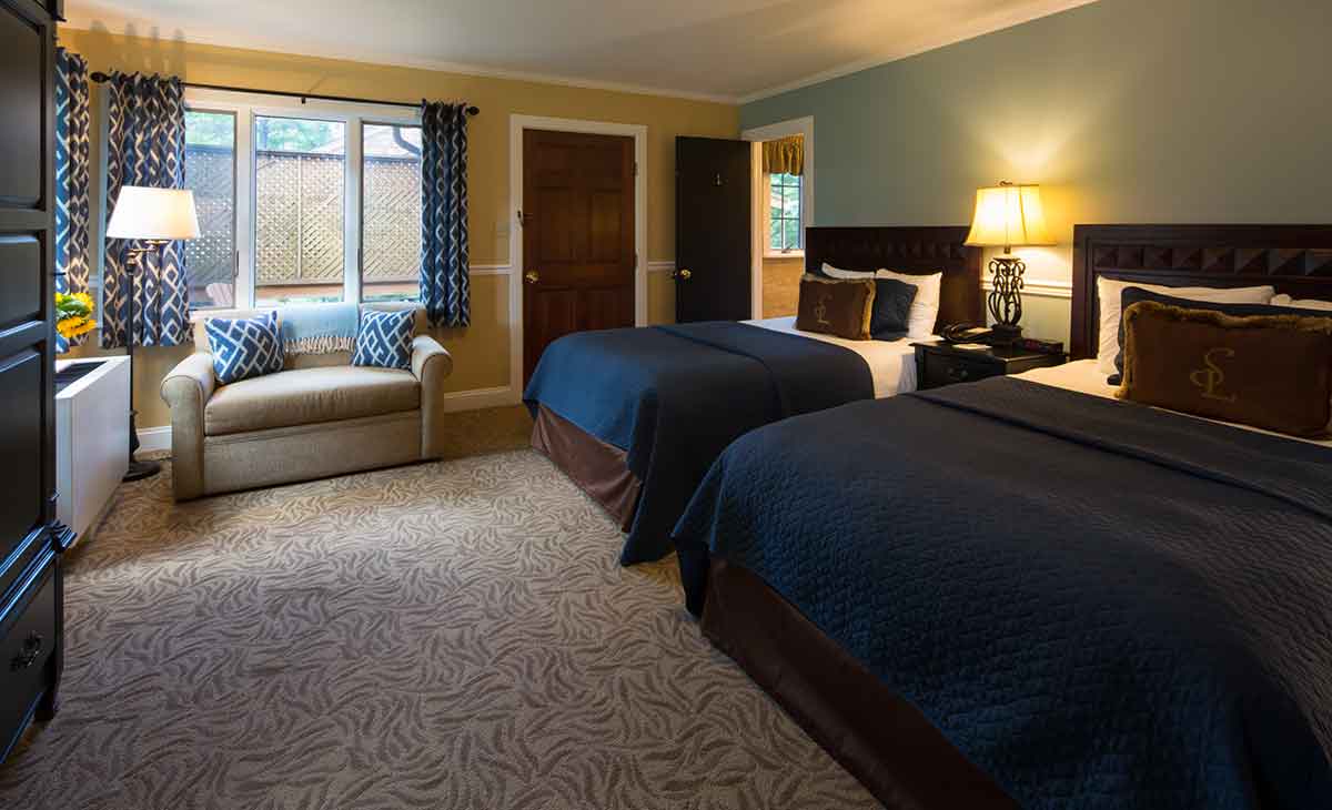 a room with two beds and a couch