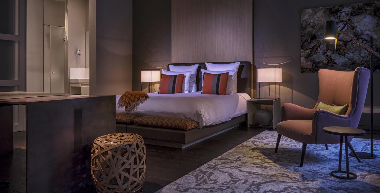 a bedroom with a bed and a chair