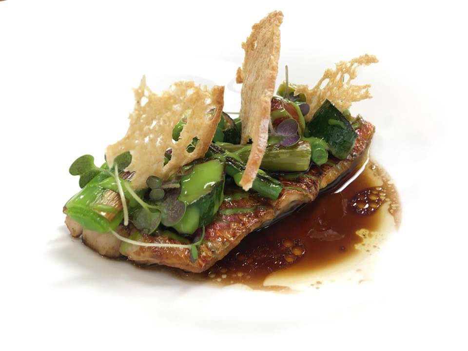 a plate of food with sauce and vegetables