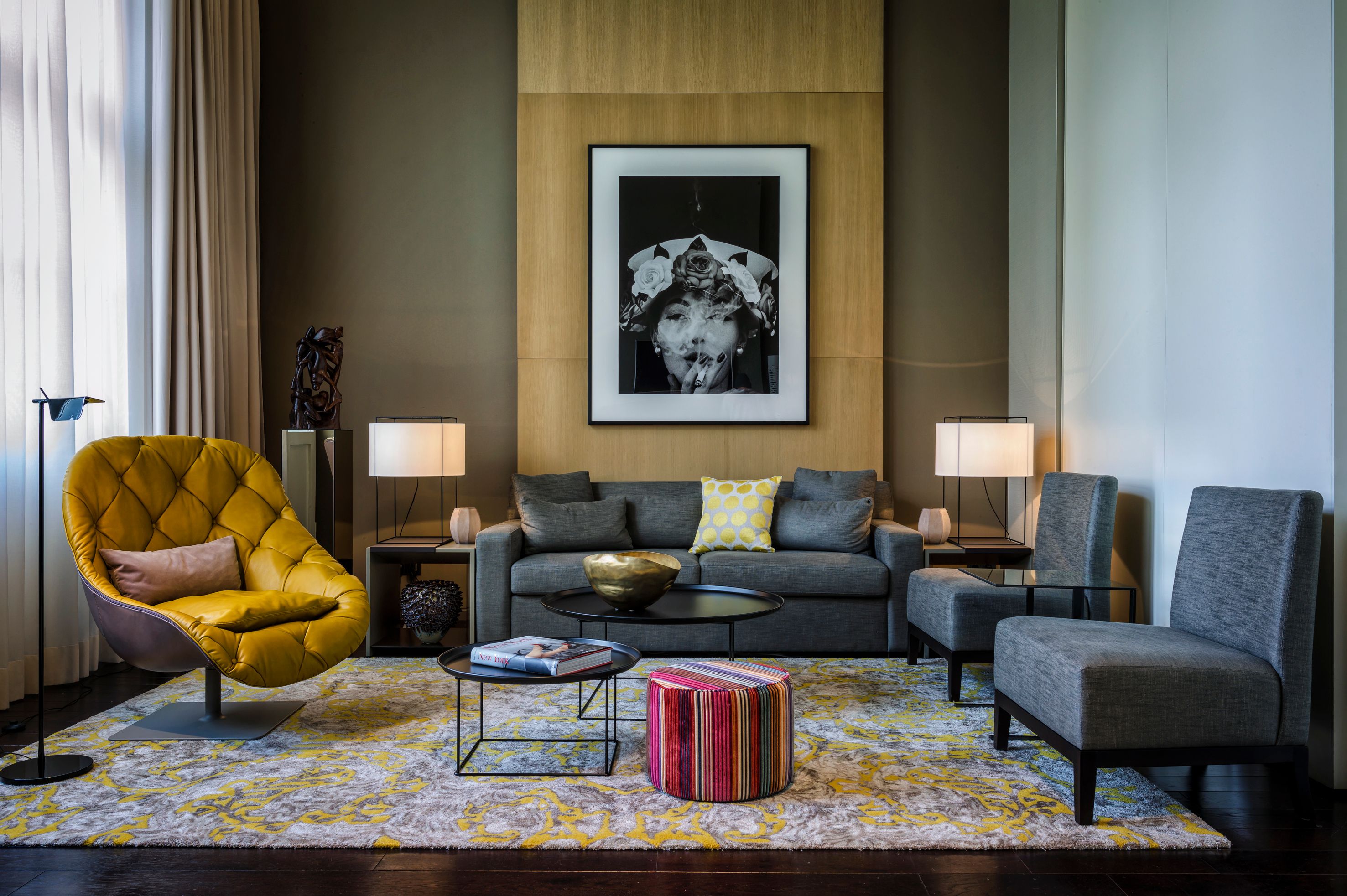 a living room with a yellow chair and a picture on the wall