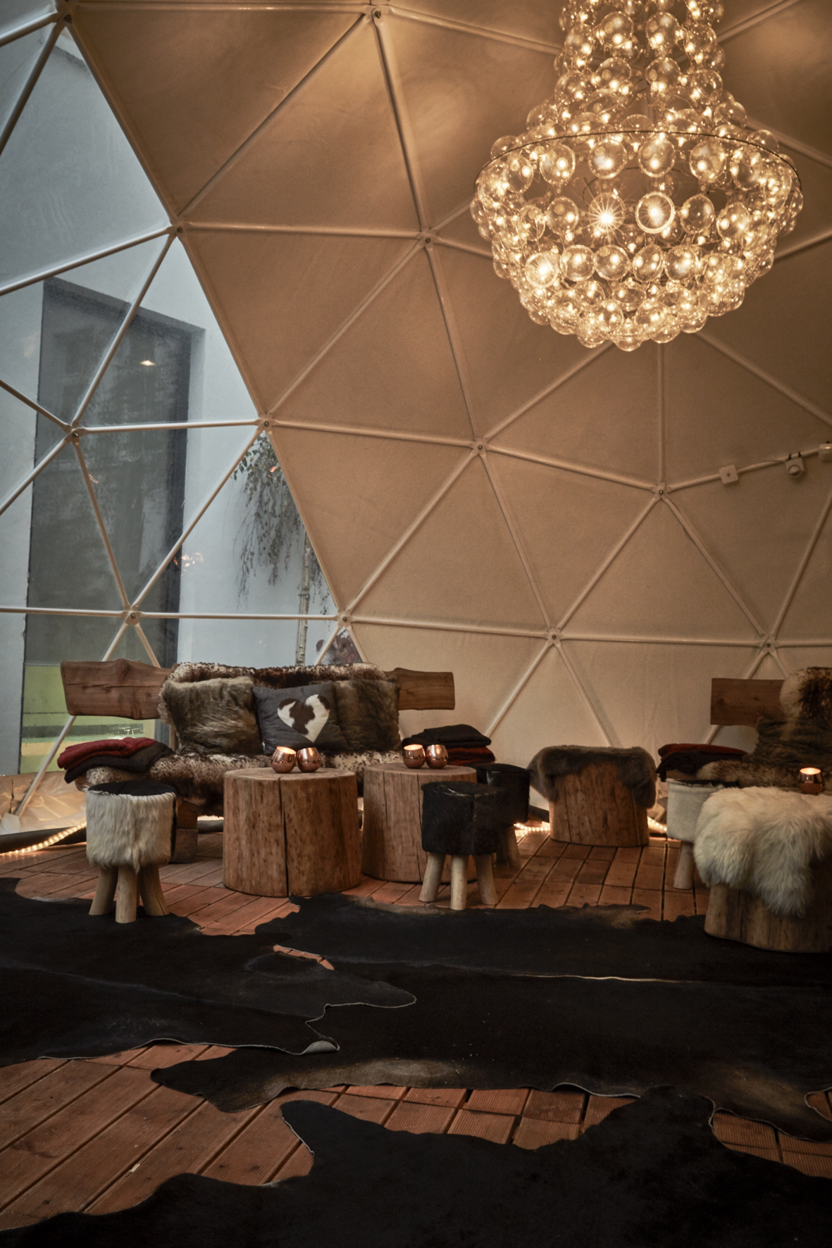 a room with a large chandelier and chairs