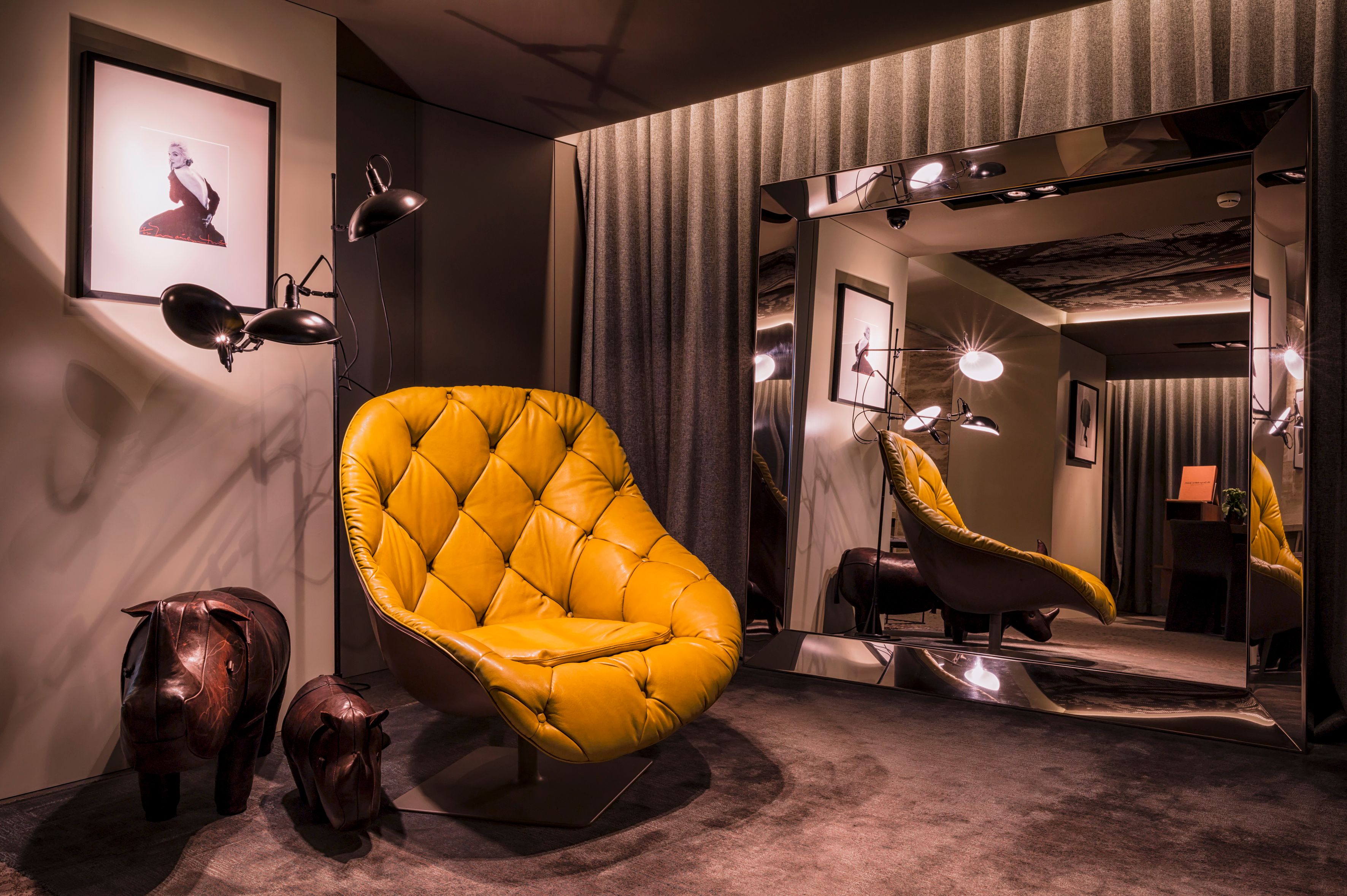a room with a mirror and a chair