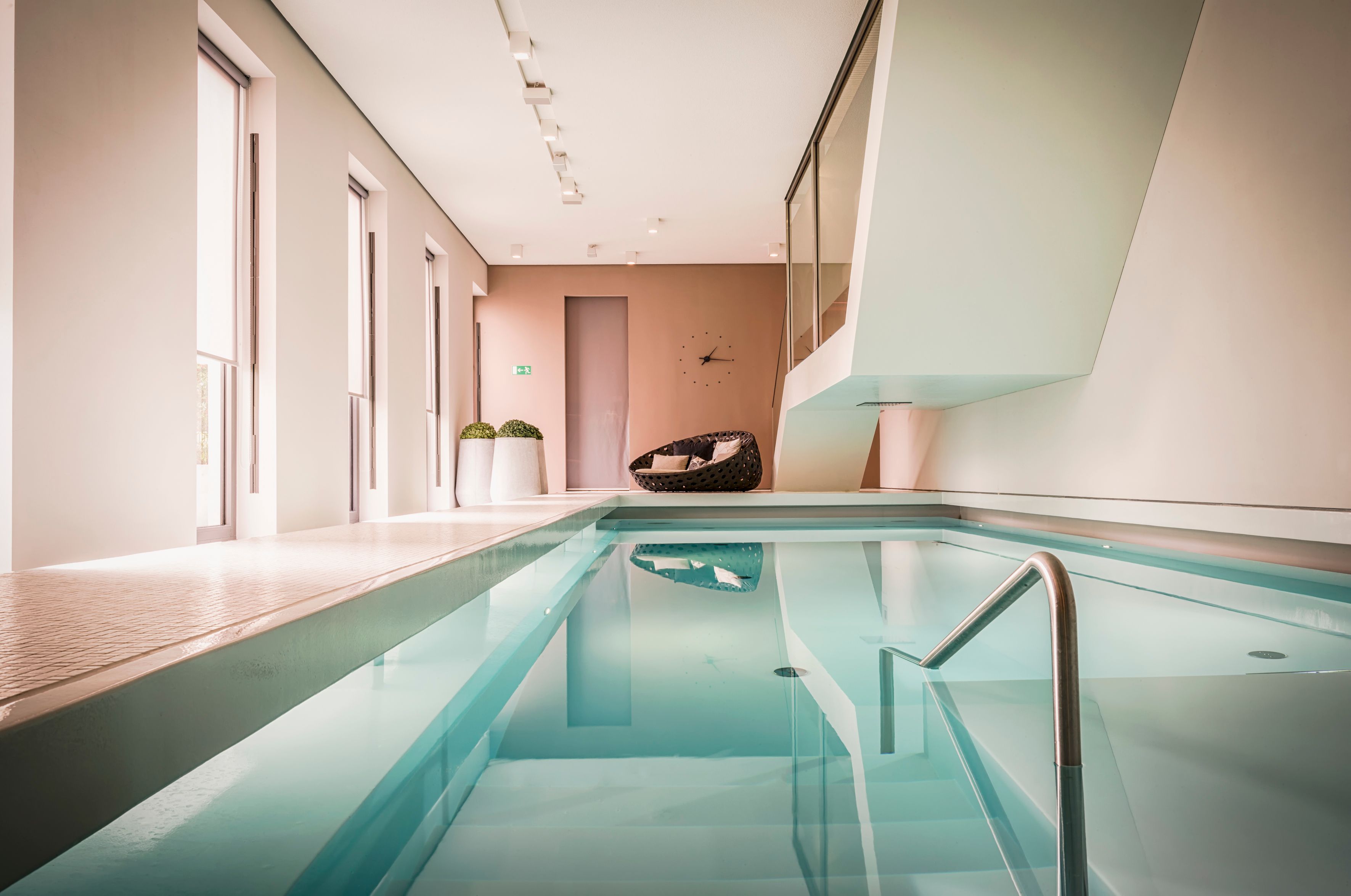 a indoor pool with a metal railing