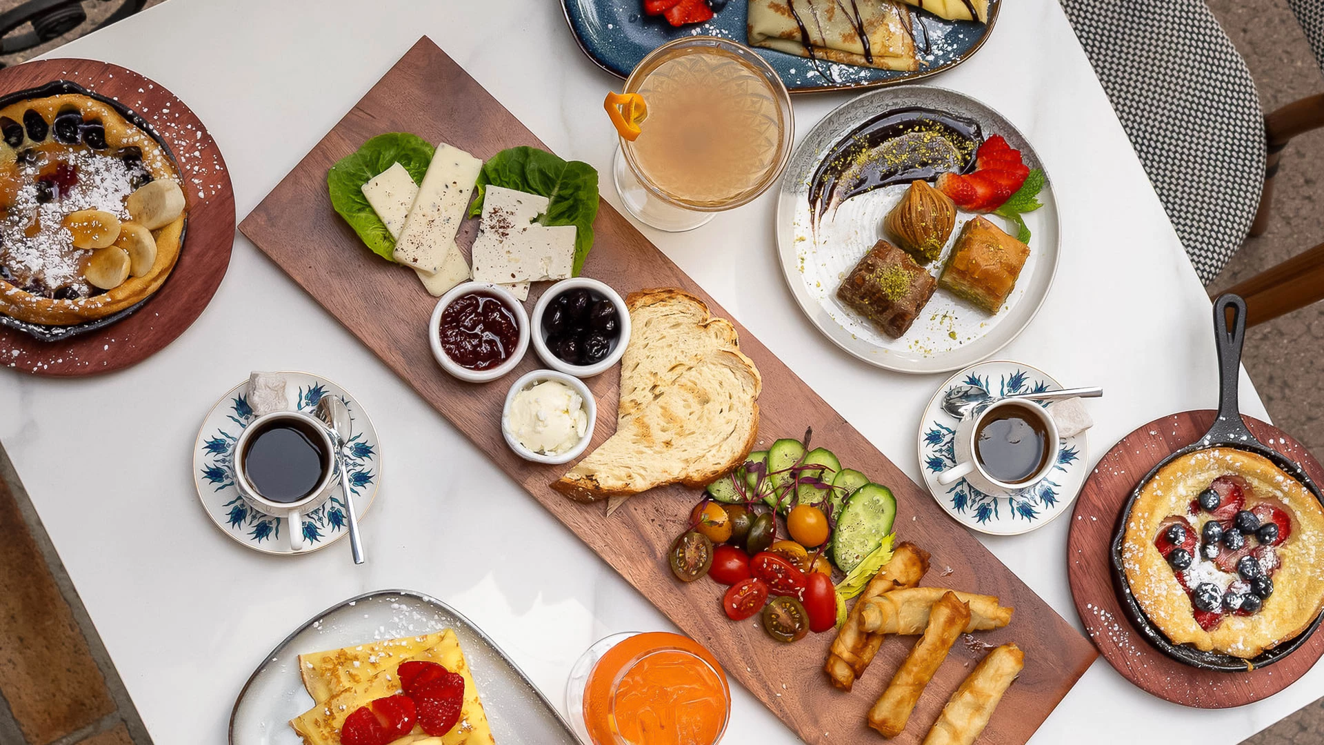 a table with plates of food and drinks