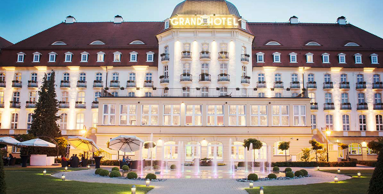 a large building with a fountain in front of it