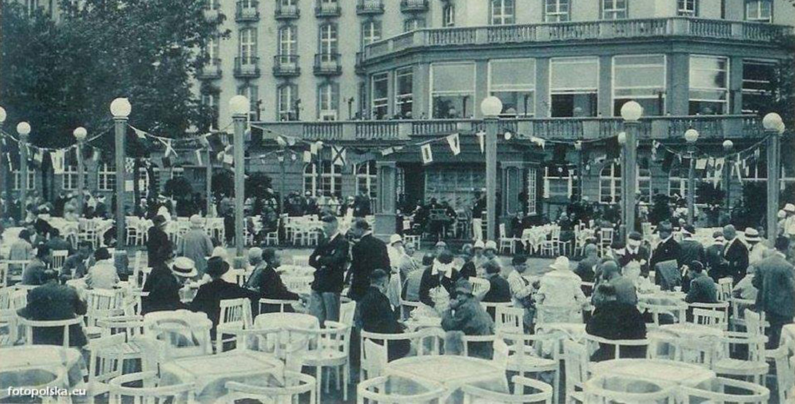 a group of people sitting at tables outside a building