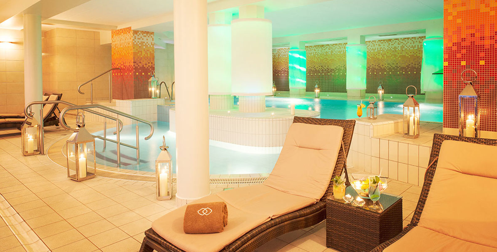 a lounge chair in a room with a pool