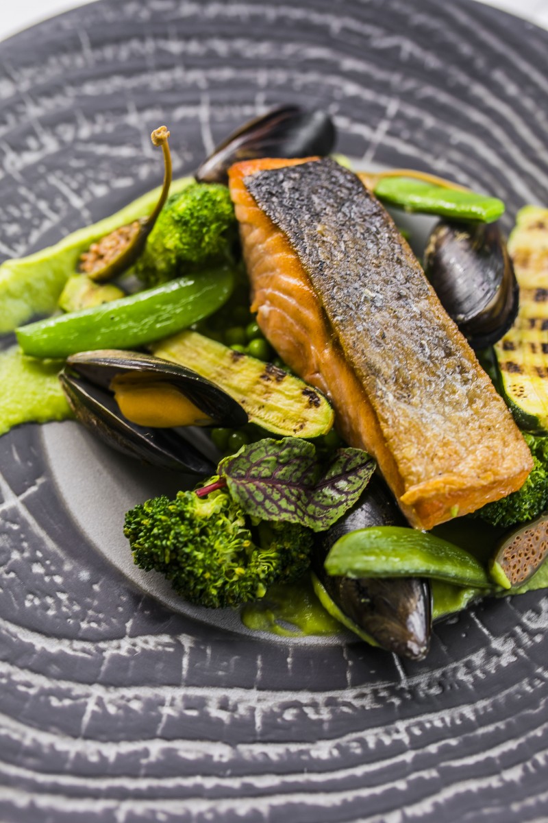 a plate of food on a black and white plate