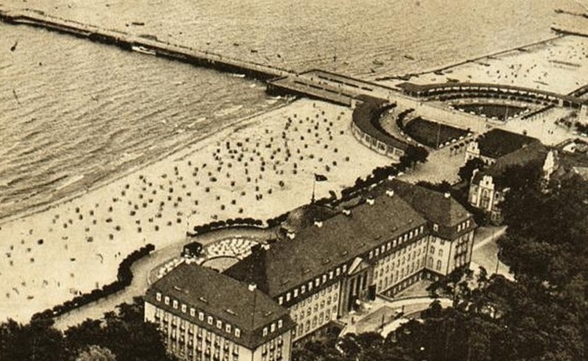a beach with buildings and a pier